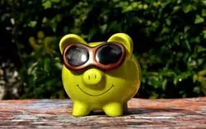 piggy bank with sunglasses loving life hacks to start saving money