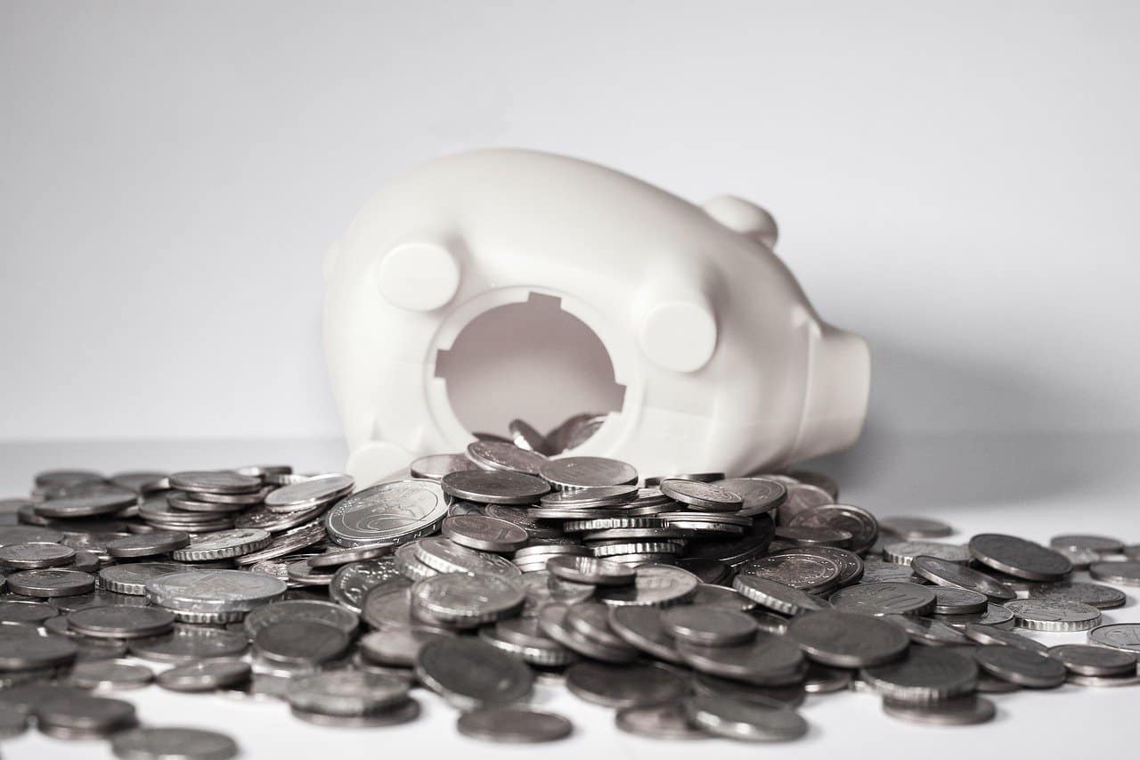 broken piggy bank with money spilled