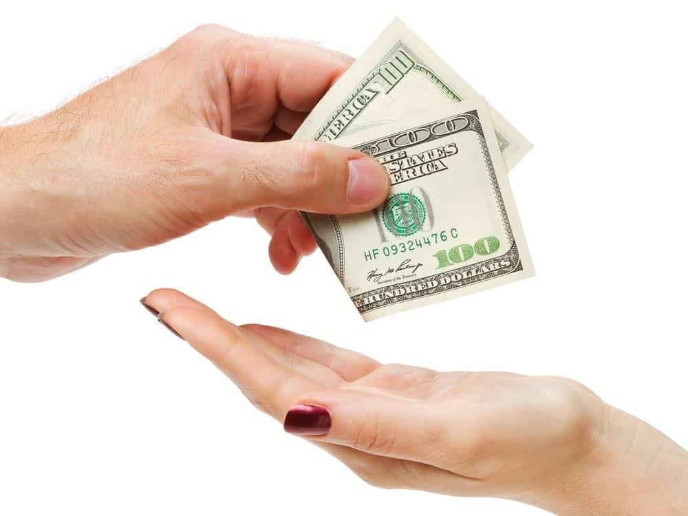 woman receiving money in left hand