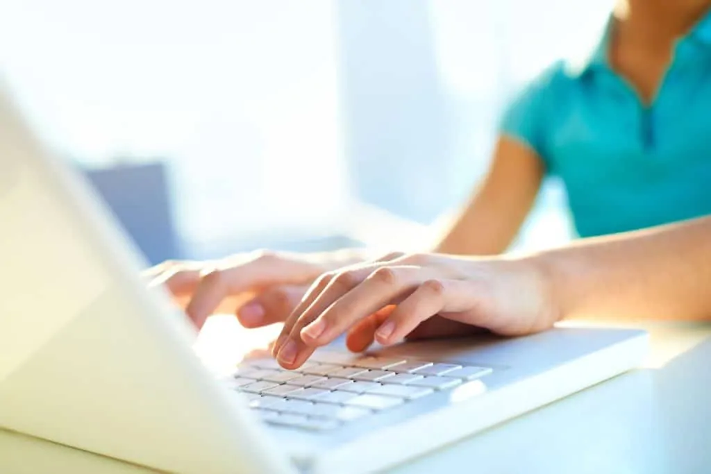 woman on laptop making money online typing names