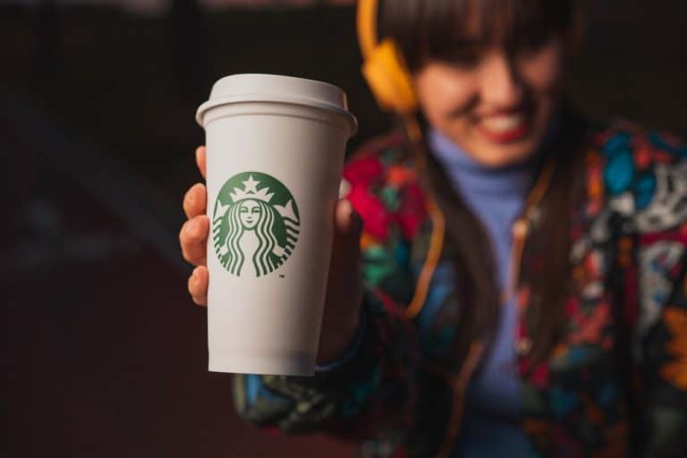 woman holding free Starbucks drink