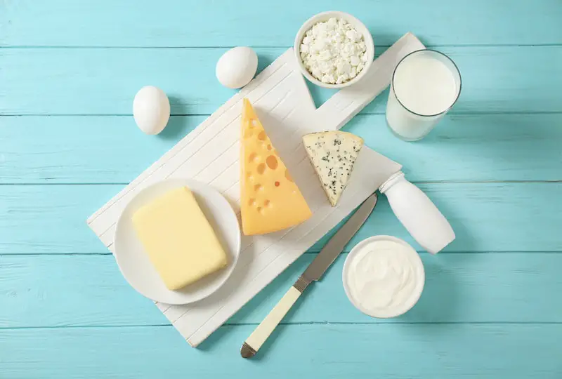 Fresh dairy products and eggs on wooden background