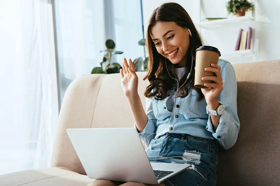 Woman Chatting To Online Friend On Laptop 