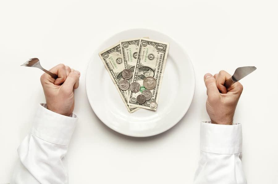 woman holding knife and fork with no money