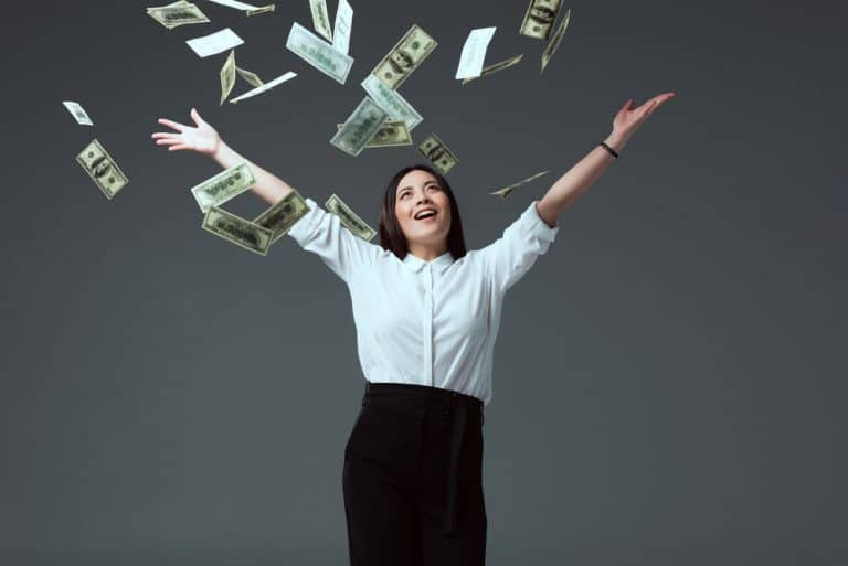 business woman with money falling down