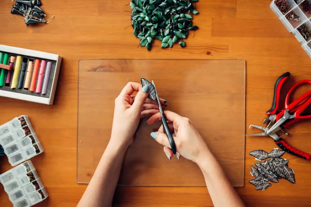 woman making handmade jewelry profitable craft to sell